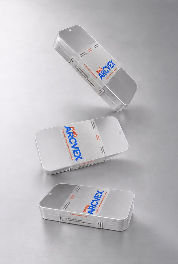 Three silver rectangular boxes with blue and orange 'MONEY' branding, arranged diagonally on a reflective light gray surface.