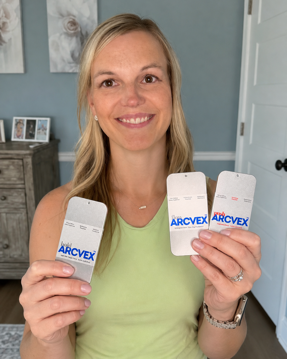 A smiling blonde woman in a light green tank top and blue jeans holds up three Arcvex product in both hands, showing them against a home interior background.